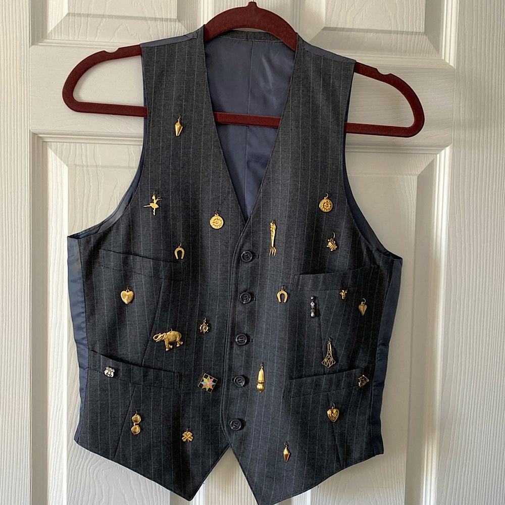 Fun, funky, vintage vest with various charms added.